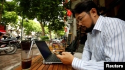 Vietnamese activist Anh Chi searches the internet at Tu Do (Freedom) cafe in Hanoi, Vietnam August 25, 2017. 