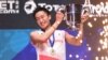 Kento Momota berpose dengan pialanya setelah menang melawan Viktor Axelsen di final tunggal putra kejuaraan badminton All England Open di Birmingham, Inggris, 10 Maret 2019. 