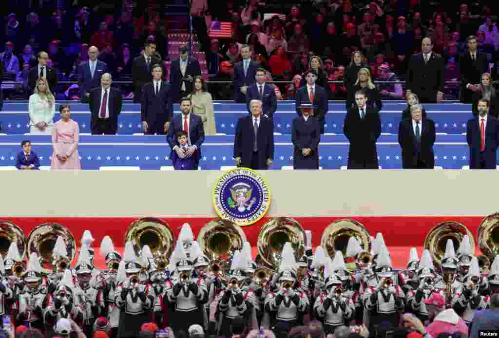 President Donald Trump, first lady Melania Trump. Vice President J.D. Vance, second lady Usha Vance, their children Ewan and Vivek, Barron Trump, Viktor Knavs, and Donald Trump Jr. attend a rally on the inauguration day inside Capital One, in Washington, Jan. 20, 2025. 