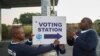 Electoral Commission of South Africa (IEC) officials put up a sign outside a polling station in Umlazi on May 29, 2024 during South Africa’s general election.