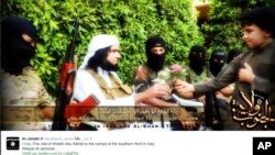 FILE - This screen grab from an Islamic State group affiliated Twitter account, taken Sunday, Sept. 20, 2014, purports to show senior military commander Abu Wahib handing a flower to a child while visiting southern Iraq, as part of the group's broad social media campaign.