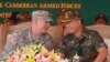 Lt. Gen. Hun Manet, right, son of Cambodian Prime Minister Hun Sen and deputy commander of the Royal Cambodian Army and Commander of the National Counter Terror Special Force, talks with an U.S. Army Pacific Representative Brg. Gen. John Goodale, left, as they preside over a U.S.-backed peacekeeping exercise dubbed "Angkor Sentinel 2014" at the Cambodian tank command headquarters in Kampong Speu province, 60 kilometers (37 miles) west of Phnom Penh, Cambodia, Monday, April 21, 2014. (AP Photo/Heng Sinith)