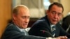 FILE - Russian President Vladimir Putin, left, gestures as Mass Media Minister Mikhail Lesin listens to him during a meeting with local press in the far eastern city of Vladivostok, Aug. 24, 2002