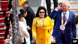 FILE - Malaysian Prime Minister Najib Razak, right, salutes the troops as he arrives with his wife, Rosmah Mansor, at Clark International Airport in Clark, Pampanga province, north of Manila, Philippines, Nov. 12, 2017.