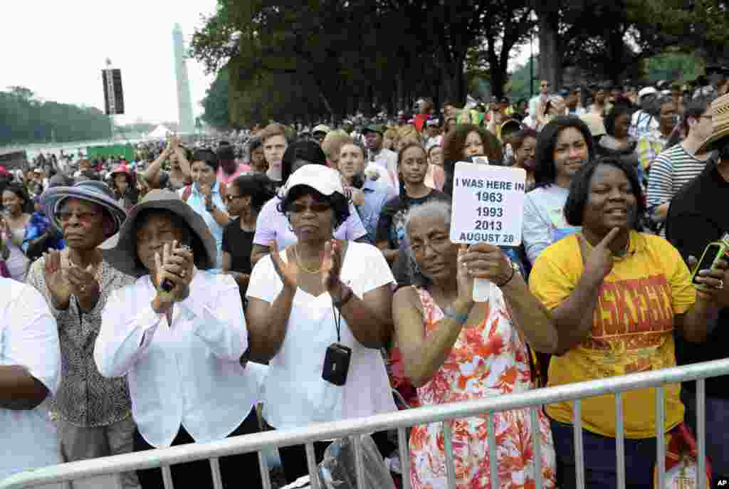Three women who attended marches in the past, from left, Armanda Hawkins of Memphis, Vera Moore of Washington, and Betty Waller Gray of Richmond, Va., (holding sign) listen to the speakers during the March on Washington, Aug. 28, 2013, at the Lincoln Memorial.