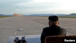 FILE - North Korean leader Kim Jong Un watches the launch of a Hwasong-12 missile in this undated photo released by North Korea's Korean Central News Agency, Sept. 16, 2017.