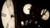 FILE - Custodian Ray Keen inspects a clock face before changing the time on the 100-year-old clock atop the Clay County Courthouse, March 8, 2014, in Clay Center, Kansas. (AP Photo/Charlie Riedel, File)