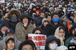 Protesters calling for the ouster of South Korea President Yoon Suk Yeol gather for the second martial law impeachment vote outside the National Assembly in Seoul on Dec. 14, 2024.