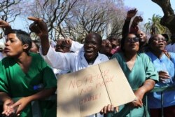 FILE - Zimbabwean medical staff march in Harare, Sept. 19, 2019. Zimbabwean doctors protesting the alleged abduction of a union leader won a high court ruling allowing them to march and handover a petition to the parliament.
