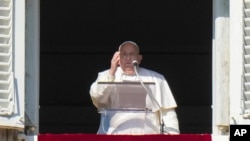 Pope Francis appears at his studio's window overlooking St. Peter's Square at The Vatican to bless pilgrims and faithful after presiding over a mass in St. Peter's Basilica on New Year's Day, Jan. 1, 2025. 