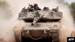 An Israeli army tank drives into position near Israel's southern border with the Gaza Strip on Dec. 11, 2024.