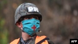 A military police officer wears a face mask as he patrols the streets during a partial curfew ordered by the government to contain the pandemic of the new coronavirus, in Amatitlan, Guatemala, on April 2, 2020.