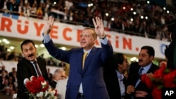 Turkey's President Recep Tayyip Erdogan waves to supporters as he arrives for a congress of the ruling Justice and Development Party (AKP) in Ankara, Turkey, May 21, 2017.