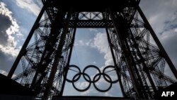 This photograph taken on June 26, 2024 shows the Olympics rings on the Eiffel Tower in Paris, on June 26, 2024. (Photo by OLYMPIA DE MAISMONT / AFP)