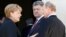 German Chancellor Angela Merkel, left, Russian President Vladimir Putin, right, and Ukrainian president-elect Petro Poroshenko, center, talk after a group photo in NOrmandy, France, June 6, 2014.