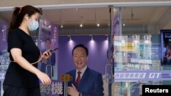 A woman walks past Foxconn's founder Terry Gou's presidential election campaign headquarter in Taipei, Taiwan, Oct. 24, 2023.