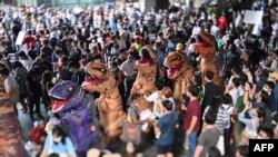 A photo taken with a tilt-shift lens shows protesters dressed in dinosaur costumes, which pro-democracy activists said represent the older generation of Thai politicians, during a 'Bad Student' rally in Bangkok, Thailand, Nov. 21, 2020.