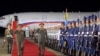 Gambar yang diambil pada 25 Juli 2023 dan dirilis oleh Kantor Berita Pusat Korea (KCNA) 26 Juli 2023 menunjukkan Menteri Pertahanan Rusia Sergei Shoigu (tengah) tiba di Bandara Internasional Pyongyang. (KCNA VIA KNS/AFP)
