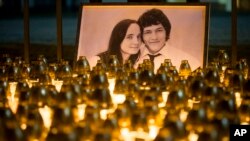 FILE - A memorial in Bratislava, Slovakia, for murdered journalist Jan Kuciak and his girlfriend, Martina Kusnirova, Feb. 28, 2018. Since 2015, several journalists have been killed in EU countries, including Kuciak whose work included investigating possible government corruption.