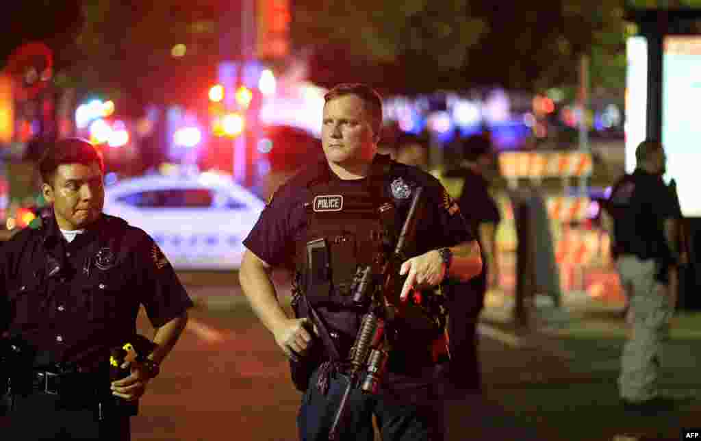 Dallas police stand watch near the scene where four Dallas police officers were shot and killed on July 7, 2016 in Dallas, Texas. 
