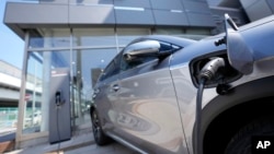 A BYD ATTO 3 electric sports utility vehicle gets charged as it is displayed at a BYD dealership on April 4, 2023, in Yokohama near Tokyo.