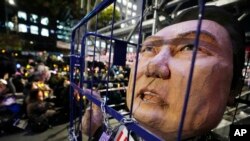 A caricature depicting an imprisoned South Korean President Yoon Suk Yeol is displayed during a rally to demand his impeachment outside the National Assembly in Seoul, South Korea, Dec. 13, 2024. 