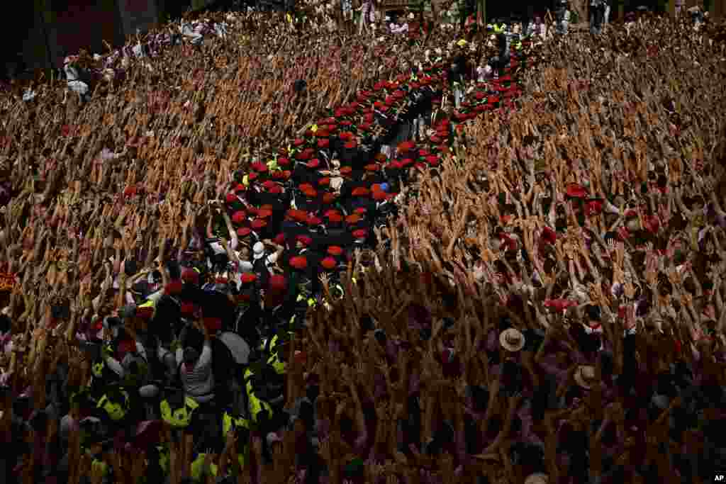 A musical band prepares to play while revelers celebrate the official opening of the 2017 San Fermin Fiestas in Pamplona, Spain. The first of eight days of the running of the bulls along the streets of the old quarter of Pamplona starts Friday.
