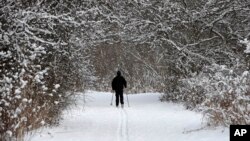 Joe Scharpf cross country skis on a trail after a fresh snowfall, Dec. 28, 2017, in Moreland Hills, Ohio. 