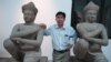 Kong Vireak, the director of the National Museum of Cambodia, with two of the returned statues known as the Kneeling Attendants, Phnom Penh, June 30, 2014. (Robert Carmichael/VOA) 