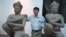 Kong Vireak, the director of the National Museum of Cambodia, with two of the returned statues known as the Kneeling Attendants, Phnom Penh, June 30, 2014. (Robert Carmichael/VOA) 