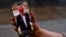 A woman shows her smartphone, displaying the @realdonaldtrump TikTok page, in Washington, Jan. 19, 2025.