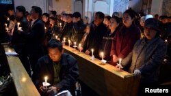 中国山西太原的一处天主教会教徒在做复活节烛光弥撒。（2013年3月30日）