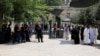 Tourists walk near Israeli police officers and recently installed metal detectors at an entrance to the compound known to Muslims as Noble Sanctuary and to Jews as Temple Mount in Jerusalem's Old City, July 23, 2017. 