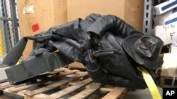 A damaged nearly century-old Confederate statue lies on a pallet in a warehouse in Durham, N.C. on Tuesday, Aug. 15, 2017.